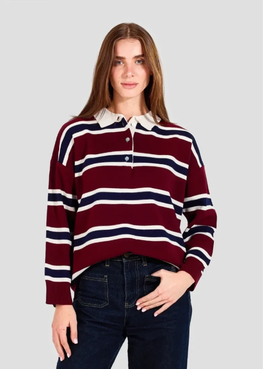 Woman wearing a maroon and navy striped sweater with a white collar on a gray background